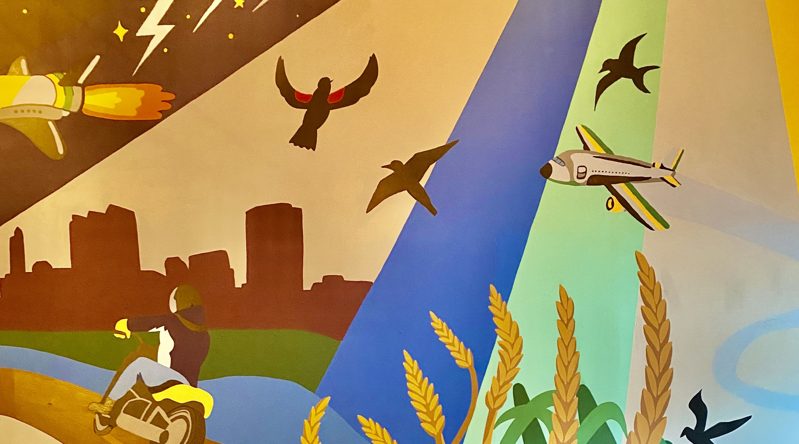 Wall mural with cityscape, motorcycle, birds and rocket