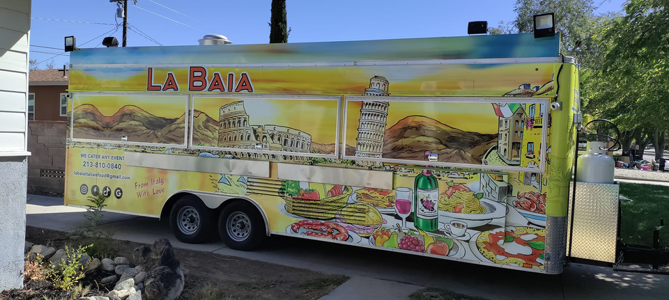 Colorful La Baia food truck with Italian-themed artwork, including landmarks like the Colosseum and Leaning Tower of Pisa, and illustrations of pasta, pizza, and wine. The side reads "From Italy with Love".